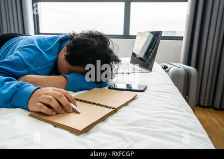 Young Asian woman sleeping in hotel room Stock Photo