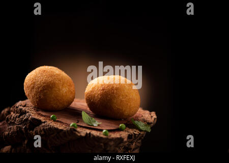 Arancini - italian rice balls which are coated with bread crumbs and then deep fried Stock Photo