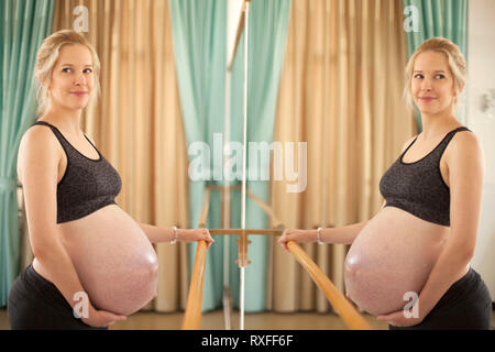 Young beautiful pregnant woman on yoga, pilates and ballet class Stock Photo