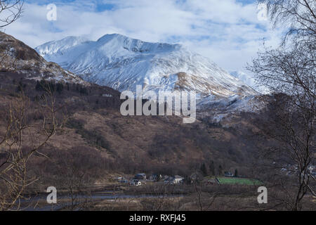 A snow covered Na Gruagaichean above the town of Kinlochleven, Highland, Scotland Stock Photo