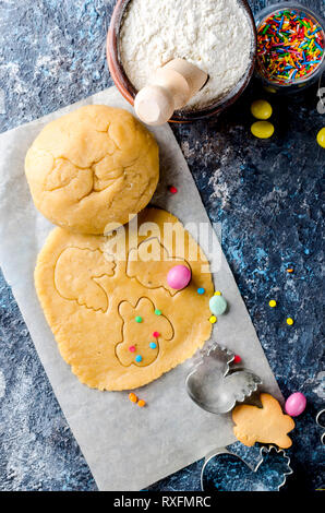 Happy Easter card. Easter biscuits,  cuttings, candy eggs and ingredients for baking rolled dough dough Stock Photo