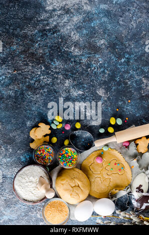 Happy Easter card. Easter biscuits,  cuttings, candy eggs and ingredients for baking rolled dough dough Stock Photo
