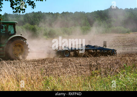 tractor plowing in the field, spring arable work, Kaliningrad region, Russia, July 21, 2018 year Stock Photo