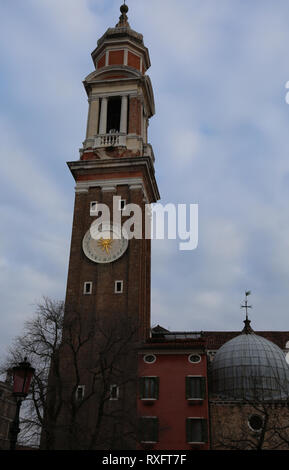 Bell tower of the church of Santi Apostoli that means  holy apostles of christ in Venice in Italy Stock Photo