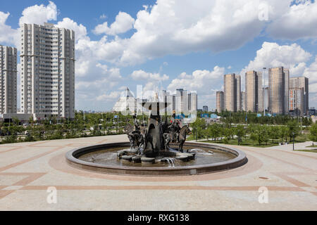 Astana, Kazakhstan, August 3 2018: Fountain in front of the National Museum and the Palace of Peace and Reconciliation in the background Stock Photo