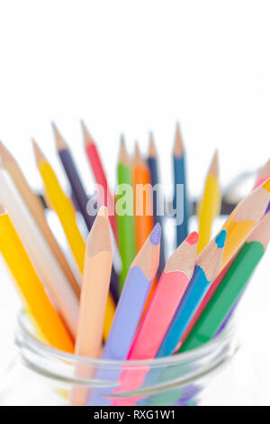 Colorful pencils in glass holder on a white background Stock Photo