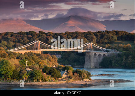 Late evening light on the Menai Bridge and Snowdonia Mountains, Menai Straits, Anglesey, North Wales, UK Stock Photo