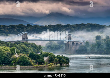 Low Lying Mist envelopes the Menai Bridge & Snowdonia Mountains, Anglesey, North Wales, UK Stock Photo