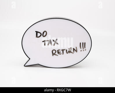 Do your tax return concept with text in speech bubble on white background Stock Photo