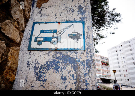 Old no parking sign on wall Stock Photo