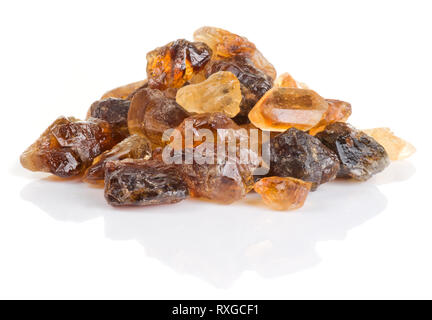 Crystals of brown unrefined cane sugar isolated on white with shadow and reflection Stock Photo