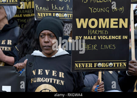 London, UK. 9th March 2019. A woman seen holding a placard during the Million Women's Rise march in London.  Thousands of women marched through central London to a rally in Trafalgar Square in London demanding freedom and justice and the end of male violence against them. ‘Never Forgotten’ was the theme for this year's march and participants commemorated the lives of girls and women who have been killed by mens’s violence. Credit: SOPA Images Limited/Alamy Live News Stock Photo