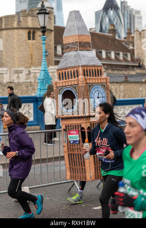 Big Ben costume runner Lukas Bates running in the Vitality Big Half half marathon crossing Tower Bridge, London, UK. Stock Photo