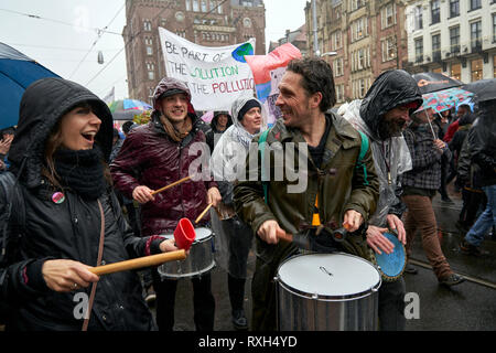 Several percussion groups take part in the march against climate change.. Summoned by civil associations and NGOs, thousands of people demonstrated today in Amsterdam to demand that governments act decisively in the face of the increasingly imminent danger posed by climate change. Stock Photo