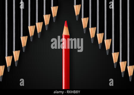 Business concept of disruption, leadership or think different; red pencil dividing row of black pencils in opposite direction; minimal concept Stock Photo