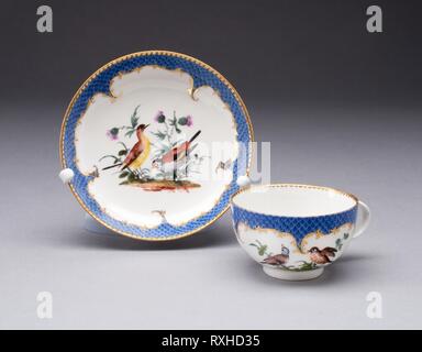 Cup and Saucer. Meissen Porcelain Manufactory; German, founded 1710. Date: 1755-1765. Dimensions: Cup: 4.3 x 7.5 cm (1 11/16 x 2 15/16 in.); Saucer: 2.5 x 11.9 cm (1 x 4 11/16 in.). Hard-paste porcelain, polychrome enamels, and gilding. Origin: Meissen. Museum: The Chicago Art Institute. Stock Photo