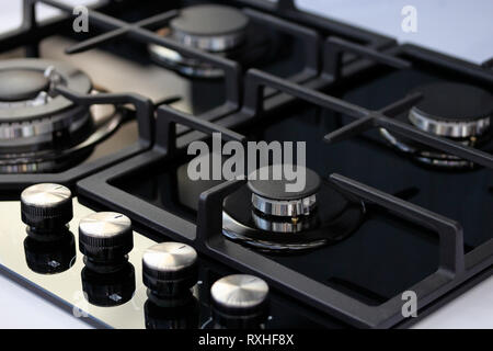Modern auto ignition gas stove with four burners. Selective focus. Stock Photo
