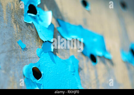 Perforated Steel Sheet with Peeling Blue Paint. Abstract Background of Aged Material Stock Photo