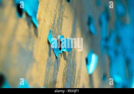 Perforated Steel Sheet with Peeling Blue Paint. Abstract Background of Aged Material Stock Photo