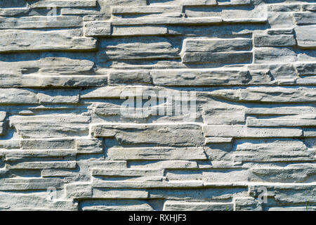 Texture of Artificial Concrete Surface Imitating Laying Under a Torn Stone. Volumetric Decorative Imprint on the Concrete. Seamless Pattern on the For Stock Photo
