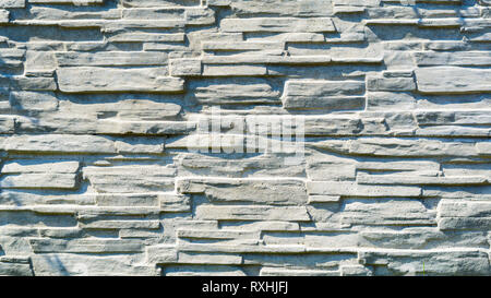 Texture of Artificial Concrete Surface Imitating Laying Under a Torn Stone. Volumetric Decorative Imprint on the Concrete. Seamless Pattern on the For Stock Photo