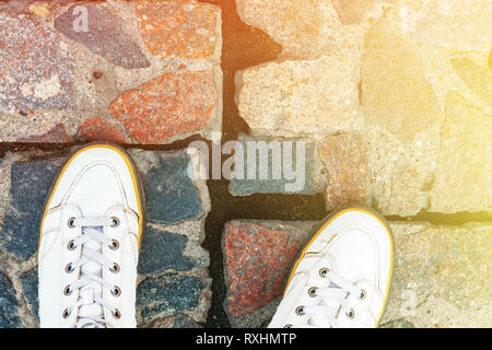White Leather Sneakers on Granite Pavement Background Top View. Copy Space Stock Photo
