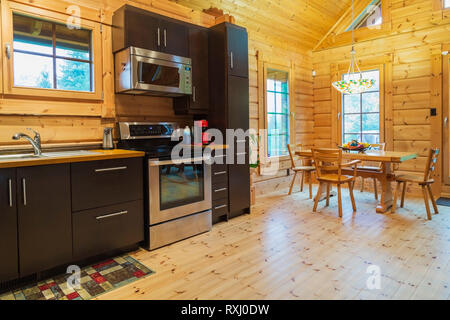 Natural Wood Countertops And Brown Cabinets With Microwave Oven