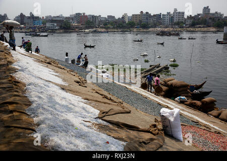 Recycled plastic chips drying on the bank of the Buriganga River in Dhaka, Bangladesh. Stock Photo