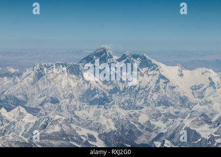 View of Mount Everest and surrounding mountains and snow covered landscape, on the flight from Lhasa, Tibet to Kathmandu, Nepal. Stock Photo