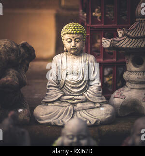 A small little Buddha statue hidden away in a market