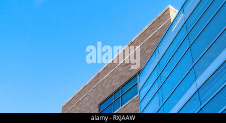 Blue sky over building with blue glass windows Stock Photo