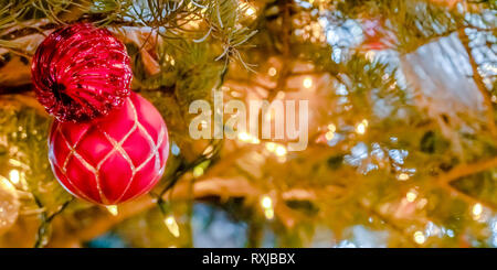 Christmas tree with lights and glittering baubles Stock Photo