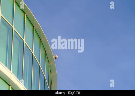 Modern building with surveillance camera on roof Stock Photo