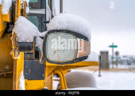 Snowy headlight of a construction vehicle in Utah Stock Photo