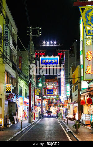 Signage, shops, people and a car brighten up the night in Chukagai (Chinatown) in Yokohama, Japan. Stock Photo