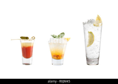 A variety of alcoholic drinks, beverages and cocktails on a white background. Three refreshing drinks in different glass goblets. Isolated. Stock Photo