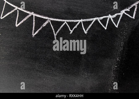 White chalk hand drawing in party flag shape on blackboard background with copy space for decoration or add text Stock Photo