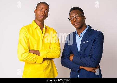 Two young African businessmen with arms crossed together Stock Photo