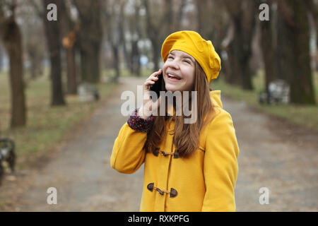 happy teenage girl talking on her cell phone Stock Photo