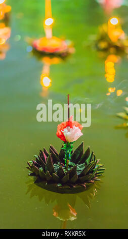 Loy Krathong festival, People buy flowers and candle to light and float on water to celebrate the Loy Krathong festival in Thailand VERTICAL FORMAT Stock Photo