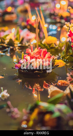 Loy Krathong festival, People buy flowers and candle to light and float on water to celebrate the Loy Krathong festival in Thailand VERTICAL FORMAT Stock Photo