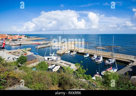 View of fishing boats and yachts moored in the harbor in Gudhjem, Bornholm island, Denmark Stock Photo
