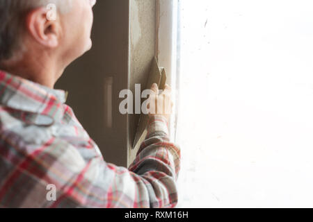 Plasterer working on a window opening Stock Photo