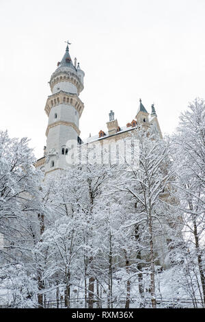 Neuschwanstein Castle in winter landscape. a nineteenth-century Romanesque Revival palace on a rugged hill above the village of Hohenschwangau near Fü Stock Photo