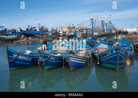 Small wooden fishing boats inside the historic harbor of Essaouira in Morocco. Stock Photo