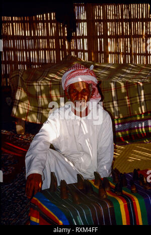 Arab folklore and history with elderly Emirati man resting and posing [for me] during the Dubai Trade Festival in the United Arab Emirates Stock Photo