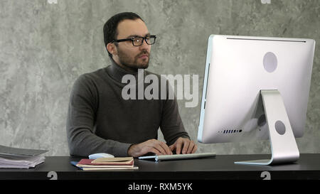 Programming. Man Working On Computer In IT Office, Sitting At Desk Writing Codes. Programmer Typing Data Code, Working On Project In Software Stock Photo
