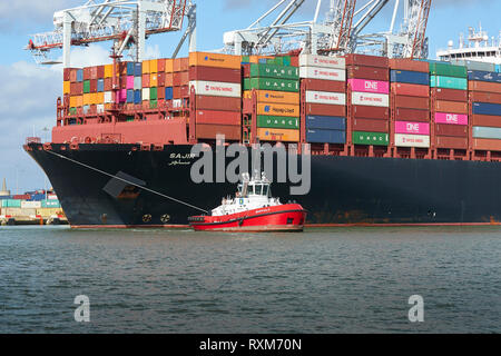 Tug boats guides a large vessel through the Panama Canal near Culebra ...