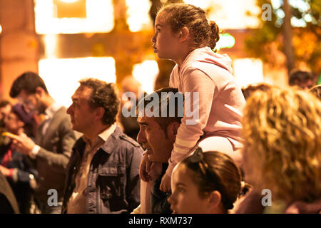 CORDOBA, SPAIN - 03, 08, 2019: Father carrying his daughter on his shoulders at the Women's Day demonstration. Stock Photo