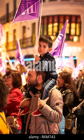 CORDOBA, SPAIN - 03, 08, 2019: Father carrying his son on his shoulders at the Women's Day demonstration. Stock Photo